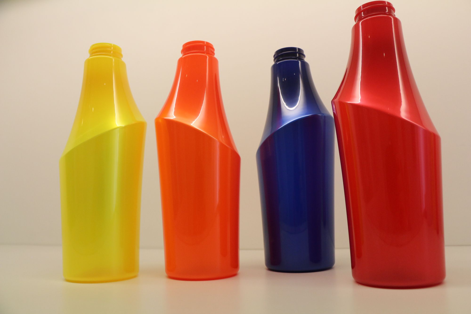 Yellow, orange, blue and red plastic bottles